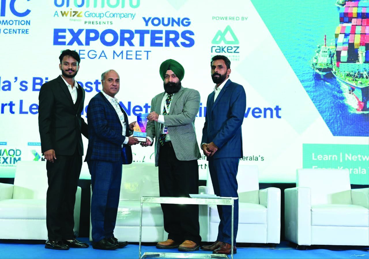 Dr. Ajay Sanker receiving an award at a corporate event