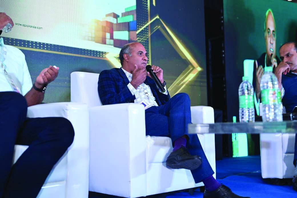 Dr. Ajay Sanker speaking on a panel at an industry event